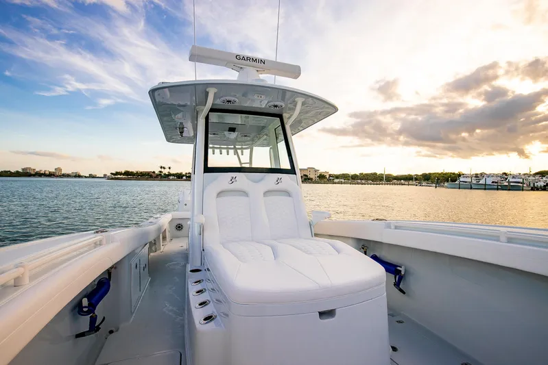 New Stock Yacht Photos Pics 2026 Yellowfin 36 Offshore boat on calm water at sunset.