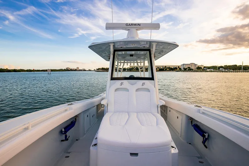 New Stock Yacht Photos Pics 2026 Yellowfin 36 Offshore boat on calm water at sunset, featuring Garmin equipment.