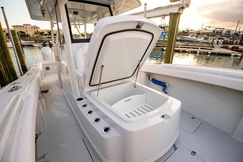 New Stock Yacht Photos Pics 2026 Yellowfin 36 Offshore boat with open storage compartment at marina.