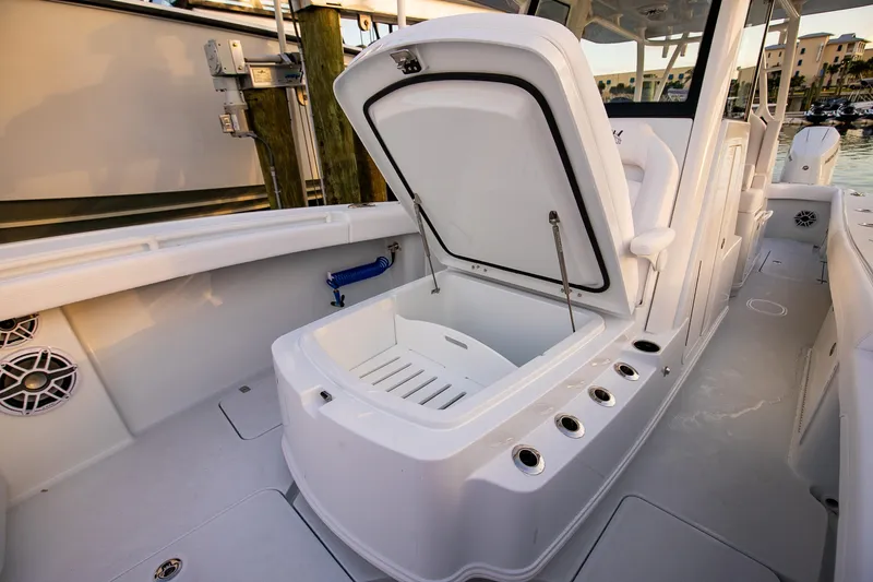 New Stock Yacht Photos Pics 2026 Yellowfin 36 Offshore boat interior with open storage compartment.