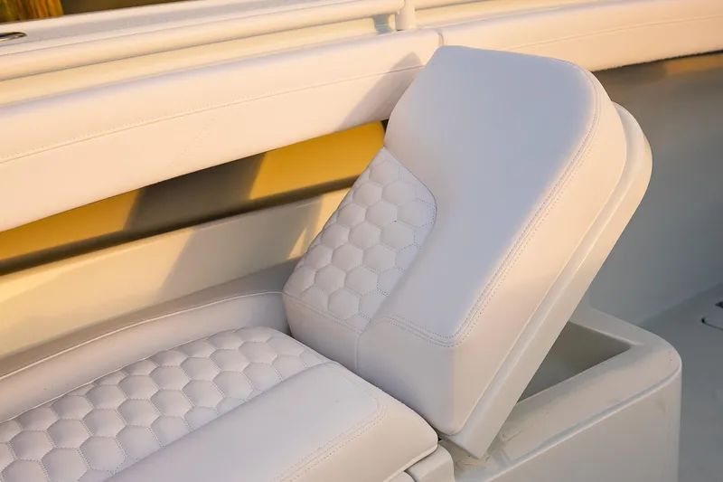 New Stock Yacht Photos Pics 2026 Yellowfin 36 Offshore boat seat with white quilted upholstery.