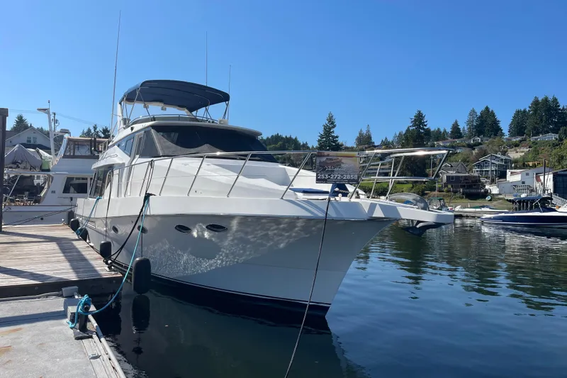  Yacht Photos Pics 1997 McKinna 48 Pilothouse yacht docked in a scenic marina.
