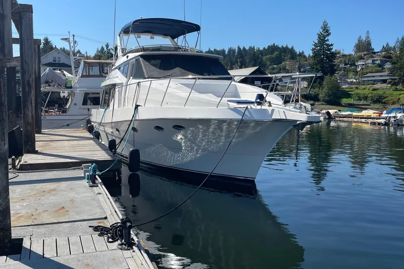  Yacht Photos Pics 1997 McKinna 48 Pilothouse yacht docked in a serene marina setting.