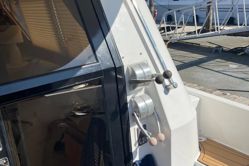  Yacht Photos Pics Close-up of 1997 McKinna 48 Pilothouse boat controls and deck area.