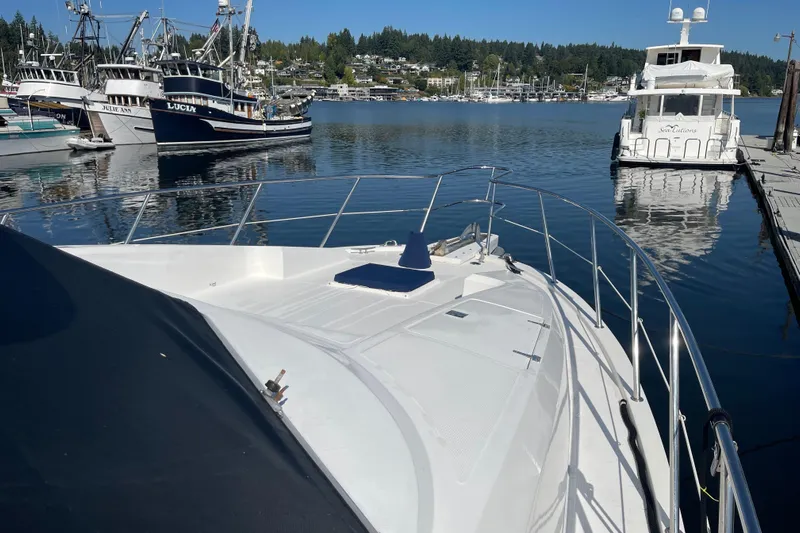  Yacht Photos Pics 1997 McKinna 48 Pilothouse yacht docked in a scenic marina.