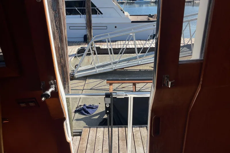  Yacht Photos Pics View from 1997 McKinna 48 Pilothouse, showing dock and nearby boat.