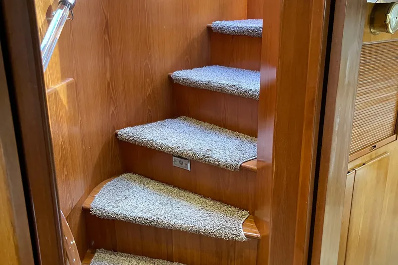  Yacht Photos Pics Carpeted wooden stairs inside 1997 McKinna 48 Pilothouse yacht.