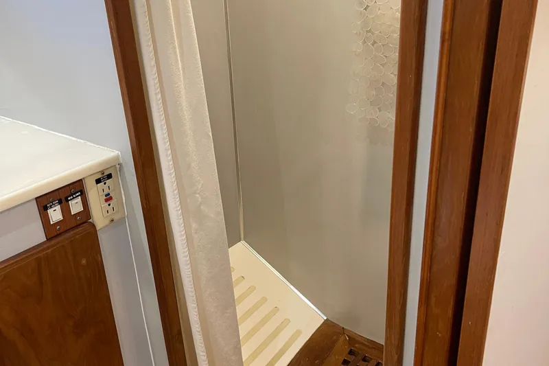  Yacht Photos Pics Shower area in 1997 McKinna 48 Pilothouse with wooden trim and control panel.