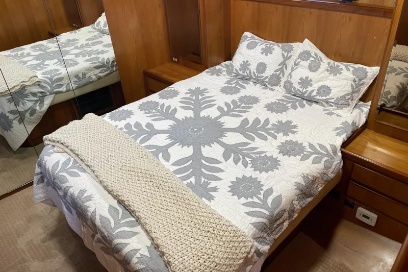  Yacht Photos Pics Cozy bedroom in 1997 McKinna 48 Pilothouse with floral bedding and wooden accents.