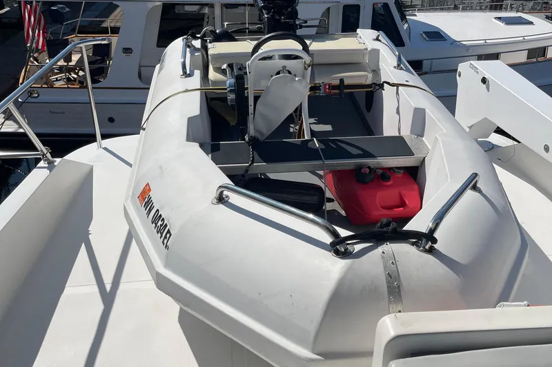  Yacht Photos Pics 1997 McKinna 48 Pilothouse yacht with inflatable dinghy on deck.