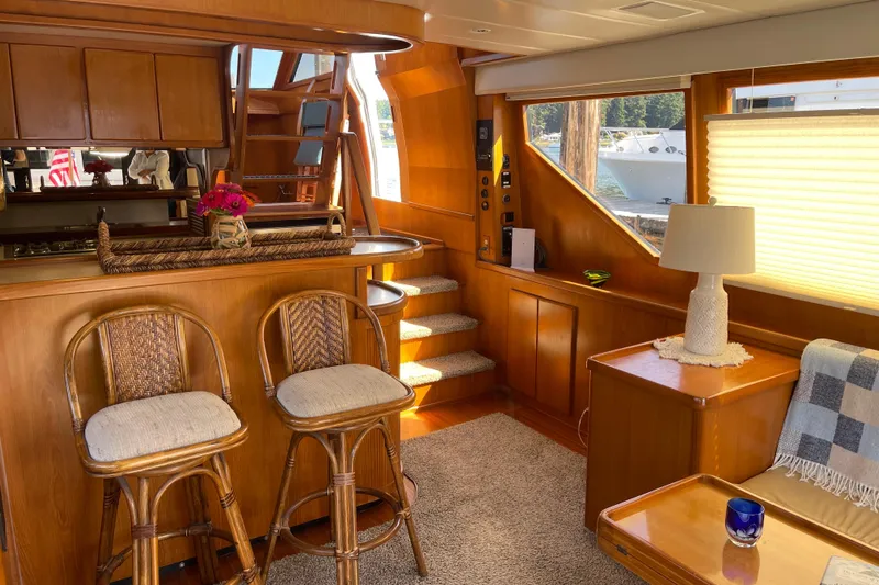  Yacht Photos Pics Luxurious interior of a 1997 McKinna 48 Pilothouse yacht with elegant wood finishes.