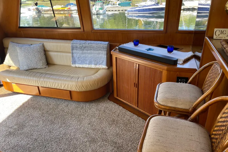  Yacht Photos Pics Luxurious interior of 1997 McKinna 48 Pilothouse yacht with elegant seating and waterfront view.
