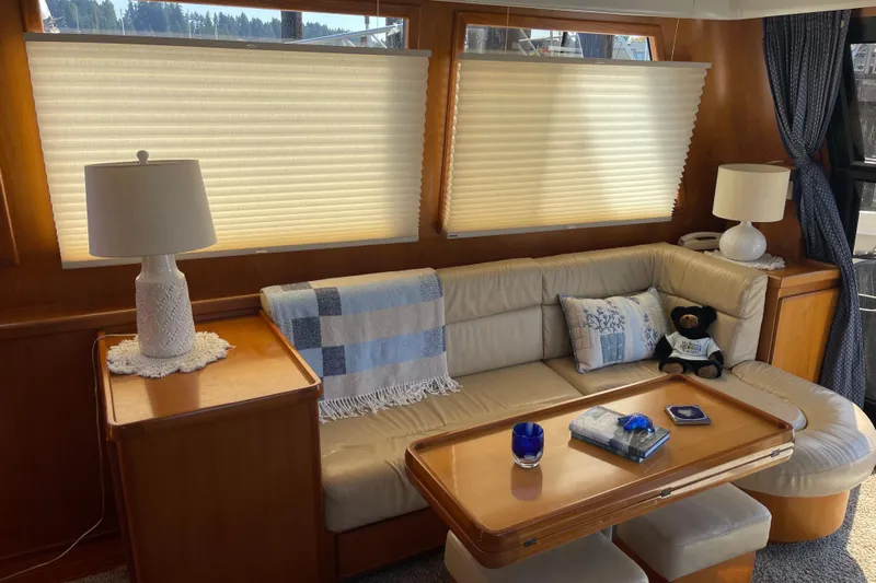  Yacht Photos Pics Cozy interior of 1997 McKinna 48 Pilothouse with plush seating and elegant decor.