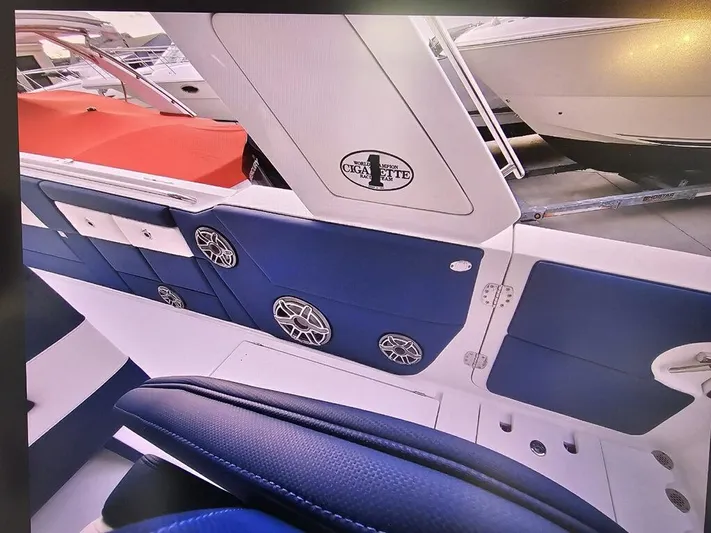  Yacht Photos Pics 2022 Cigarette 41 Nighthawk boat interior with blue seating and speaker system.