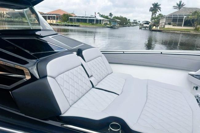 2025 Nor-Tech 400 Supersport luxury boat interior with quilted seating on a calm waterway.