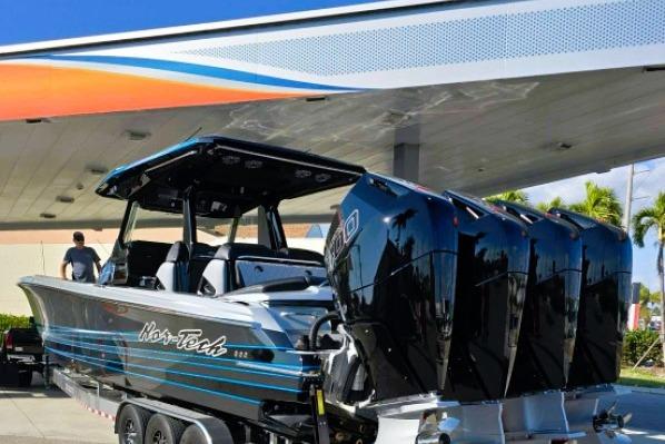 2025 Nor-Tech 400 Supersport boat with four powerful engines at a marina.