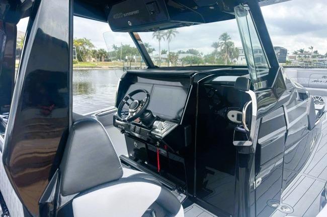 2025 Nor-Tech 400 Supersport boat interior with sleek black dashboard and steering wheel.