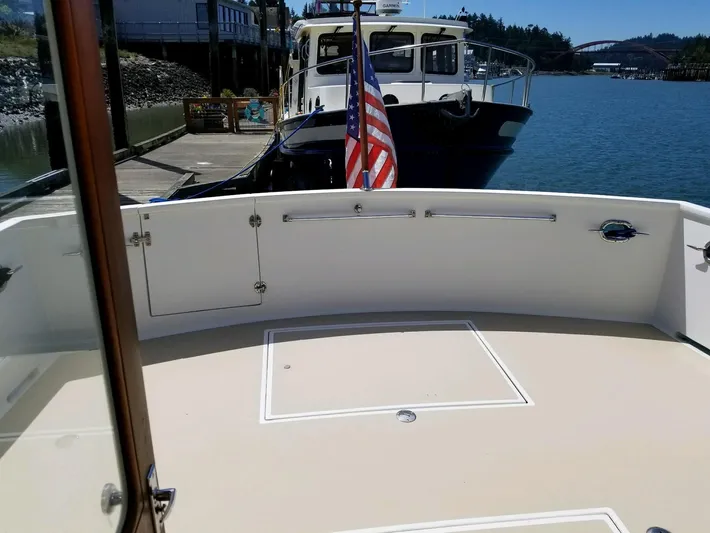 Legacy Yacht Photos Pics 1981 Ocean Alexander 50 Pilothouse yacht docked with flag.