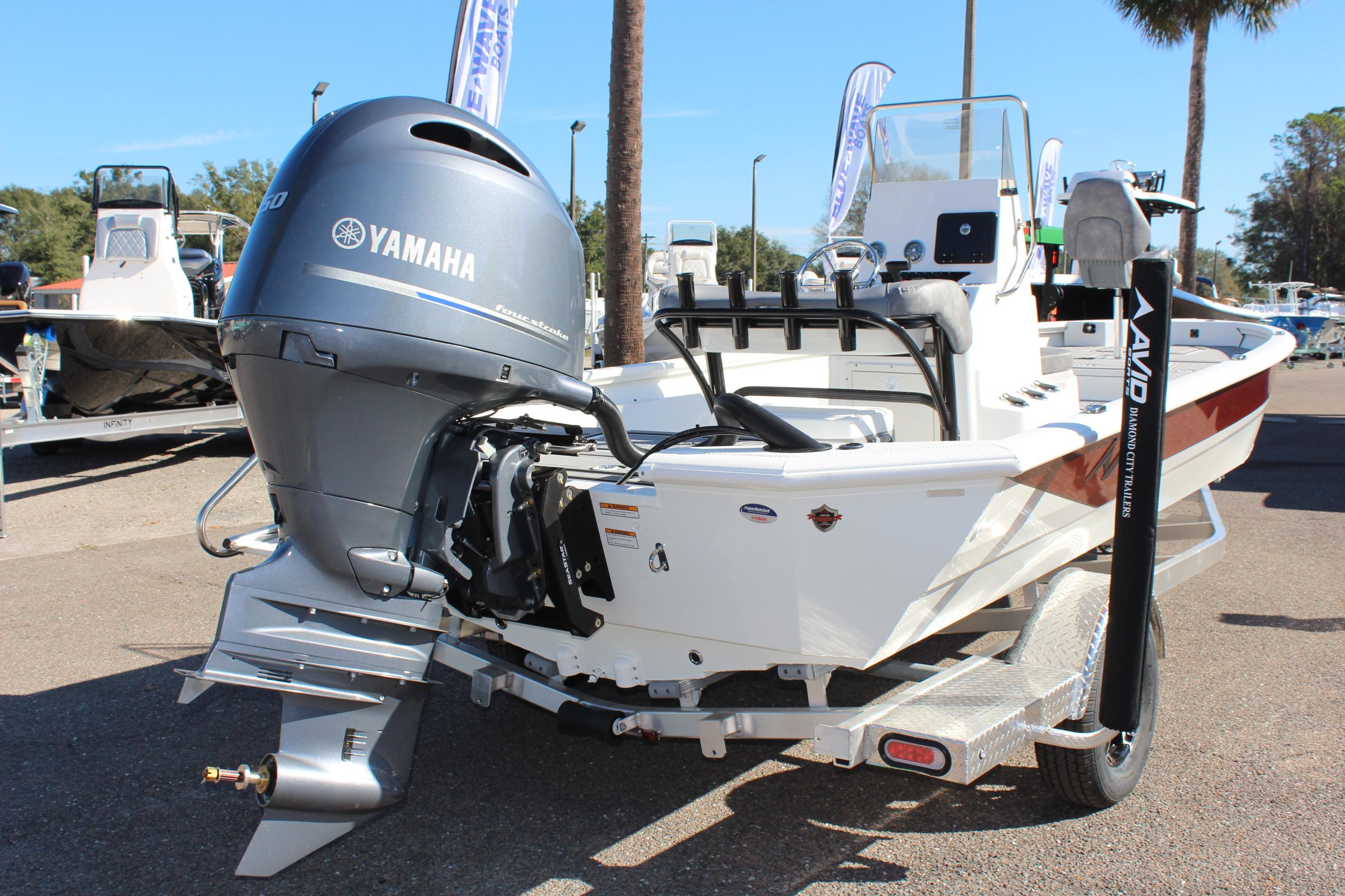 2023 Avid 21 Mag boat with Yamaha outboard motor at a marina.