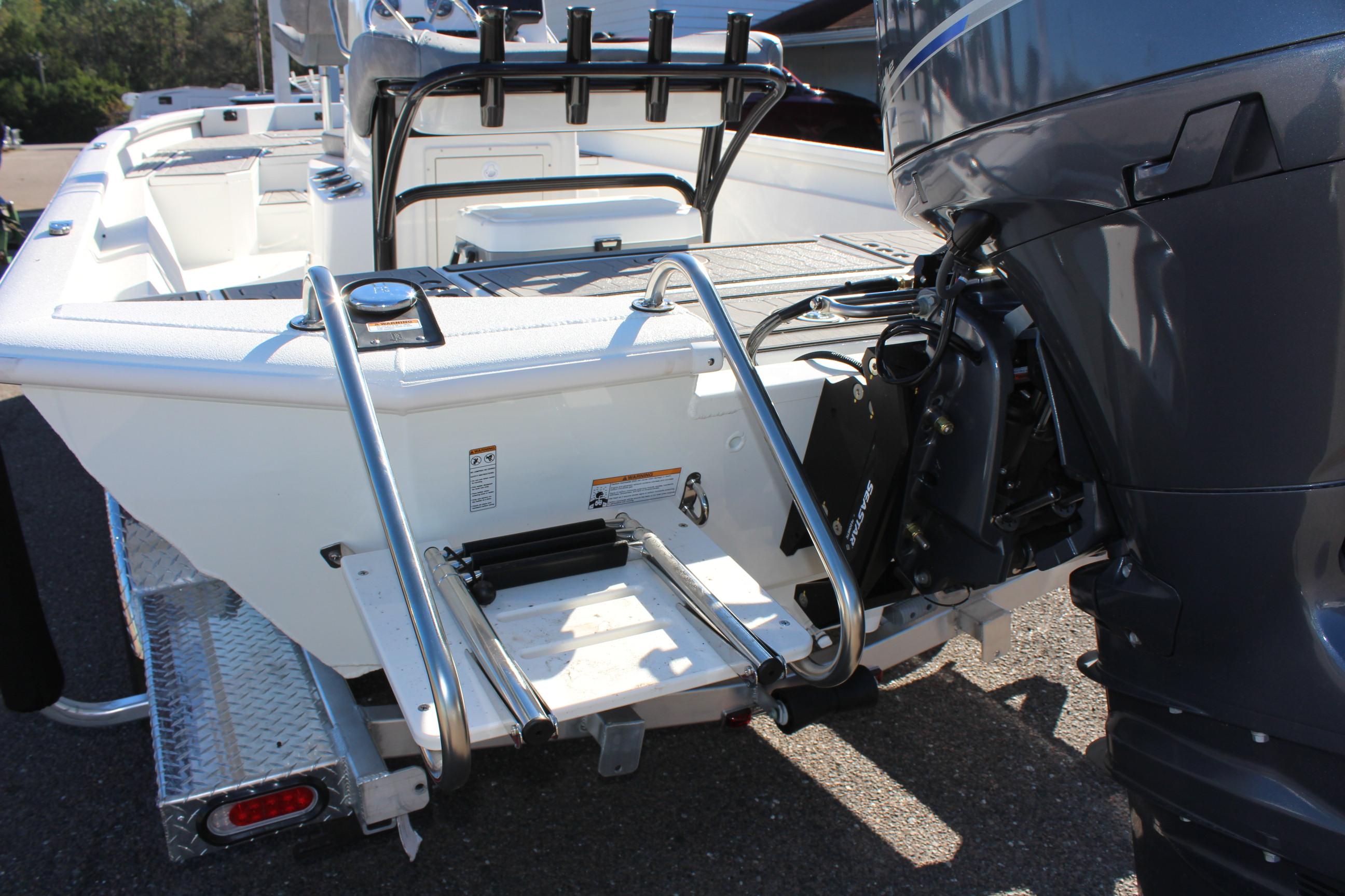 2023 Avid 21 Mag boat with outboard motor and rear ladder.