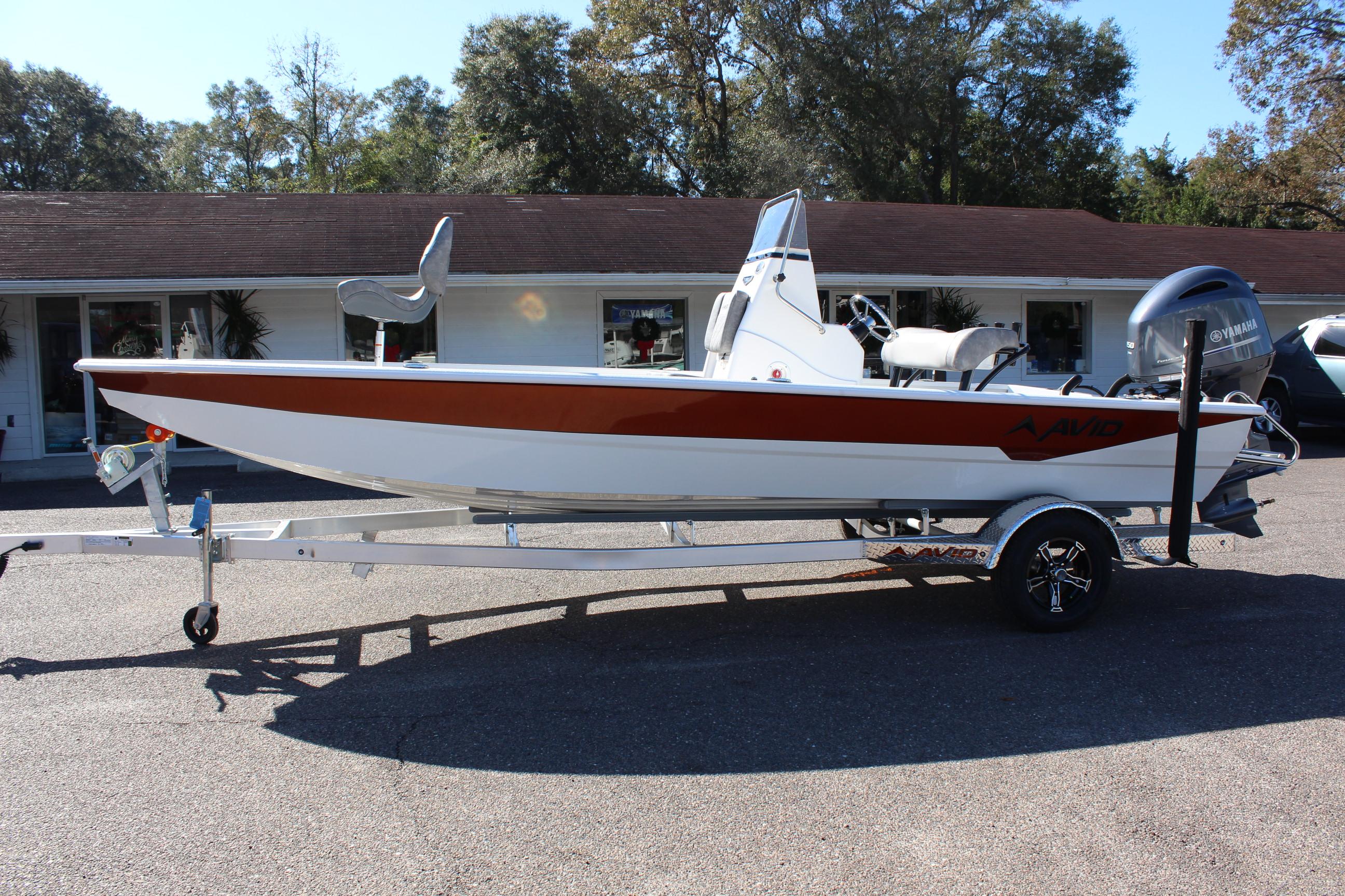 2023 Avid 21 Mag boat on trailer, parked outdoors.