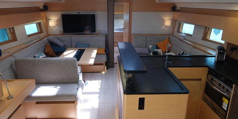Erema Yacht Photos Pics Luxurious interior of 2018 Hanse Sloop 588 yacht with modern kitchen and cozy seating area.