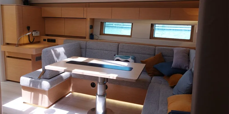 Erema Yacht Photos Pics Interior of 2018 Hanse Sloop 588 yacht with modern seating and wooden finishes.