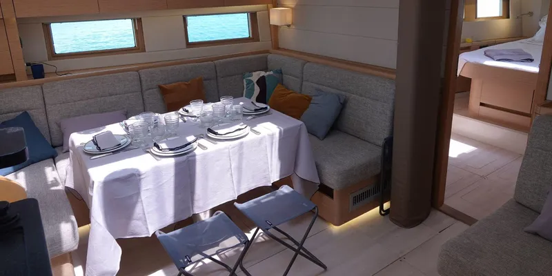Erema Yacht Photos Pics Luxurious interior of 2018 Hanse Sloop 588 yacht with elegant dining setup.