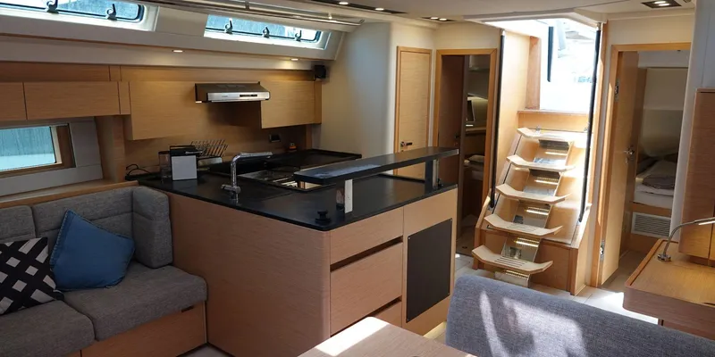 Erema Yacht Photos Pics Interior of 2018 Hanse Sloop 588 yacht with modern kitchen and seating area.