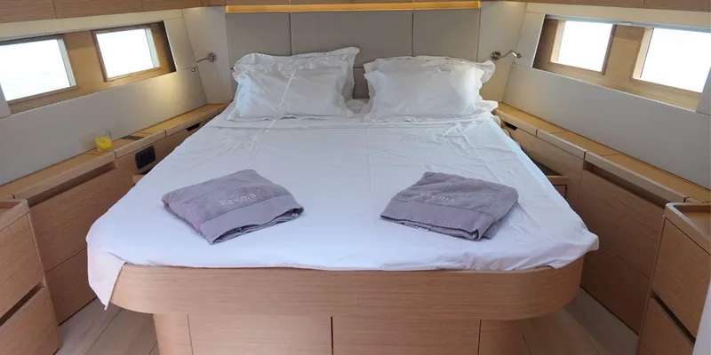 Erema Yacht Photos Pics Luxurious cabin interior of 2018 Hanse Sloop 588 yacht with cozy bed and natural light.