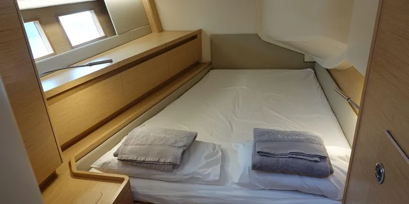 Erema Yacht Photos Pics Cozy cabin interior of 2018 Hanse Sloop 588 yacht with neatly arranged bedding.