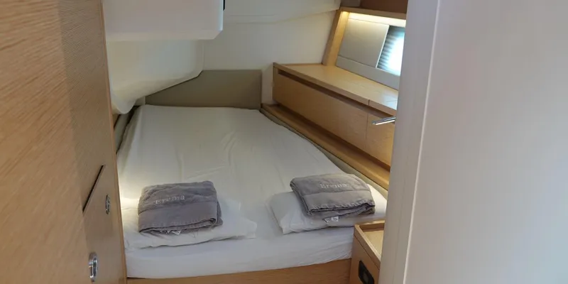 Erema Yacht Photos Pics Cozy cabin interior of 2018 Hanse Sloop 588 yacht with neatly arranged bed and towels.
