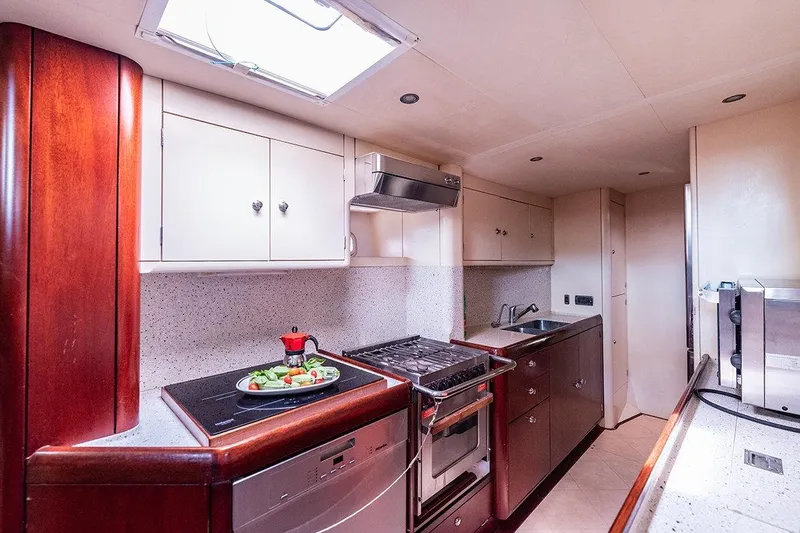 Cygnus Of Anglesey Yacht Photos Pics Luxurious Oyster 825 yacht kitchen with modern appliances and elegant wood cabinetry, 2004 model.