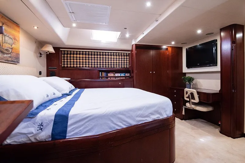 Cygnus Of Anglesey Yacht Photos Pics Luxurious interior of 2004 Oyster 825 yacht with elegant wood finishes and cozy bedding.
