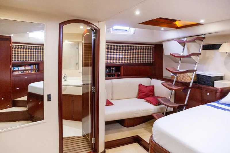 Cygnus Of Anglesey Yacht Photos Pics Luxurious interior of 2004 Oyster 825 yacht with elegant wood finishes and cozy seating.