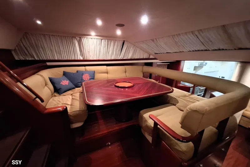 Cygnus Of Anglesey Yacht Photos Pics Luxurious interior of 2004 Oyster 825 yacht with plush seating and elegant wooden table.