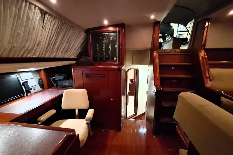 Cygnus Of Anglesey Yacht Photos Pics Luxurious interior of 2004 Oyster 825 yacht with wooden finishes and seating area.