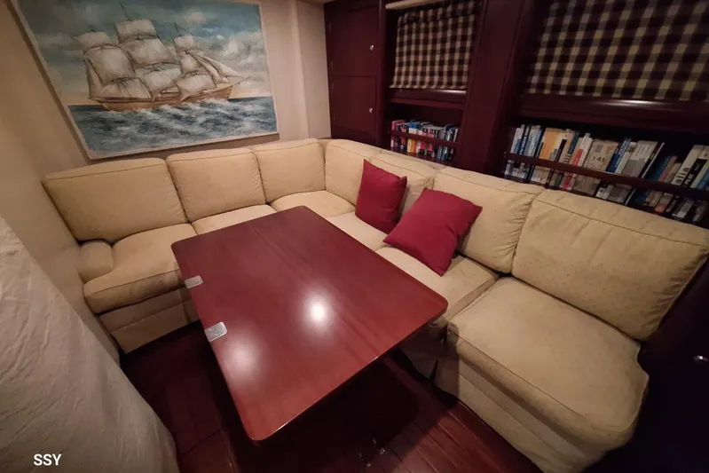 Cygnus Of Anglesey Yacht Photos Pics Luxurious interior of 2004 Oyster 825 yacht with cozy seating and nautical decor.