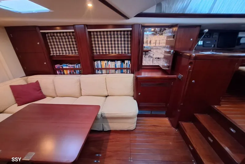 Cygnus Of Anglesey Yacht Photos Pics Luxurious interior of 2004 Oyster 825 yacht with cozy seating and wooden finishes.