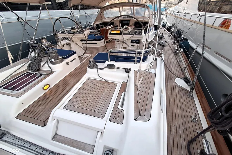 Cygnus Of Anglesey Yacht Photos Pics Luxurious 2004 Oyster 825 yacht deck with elegant wood finish and modern steering controls.