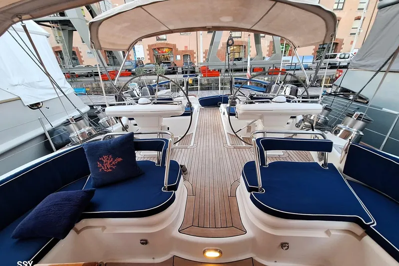 Cygnus Of Anglesey Yacht Photos Pics Luxurious 2004 Oyster 825 yacht cockpit with blue seating and elegant wooden deck.