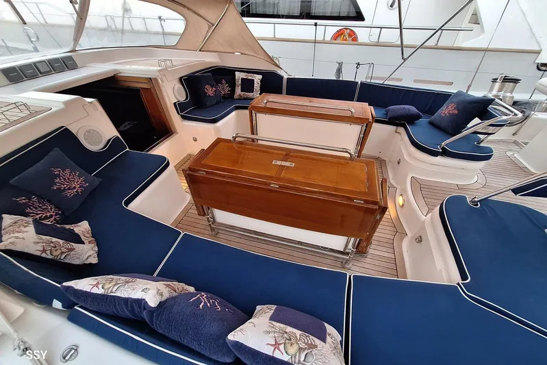 Cygnus Of Anglesey Yacht Photos Pics Luxurious seating area on a 2004 Oyster 825 yacht with nautical-themed cushions.