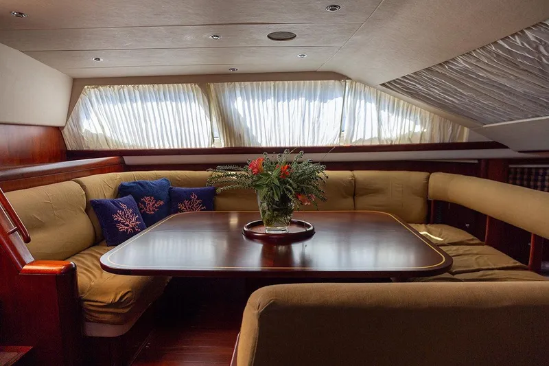 Cygnus Of Anglesey Yacht Photos Pics Luxurious interior of 2004 Oyster 825 yacht with elegant dining area and floral centerpiece.