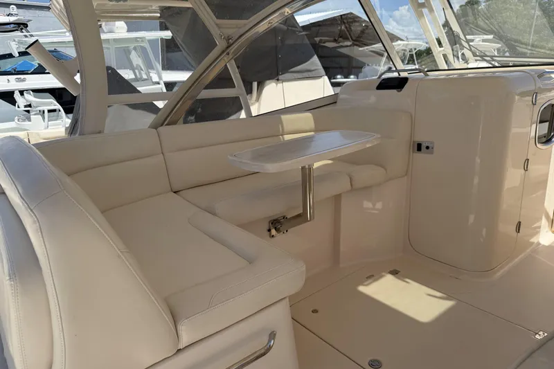 335-714 Used Yacht Photos Pics 2021 Grady-White Freedom 335 boat interior with beige seating and a small table.