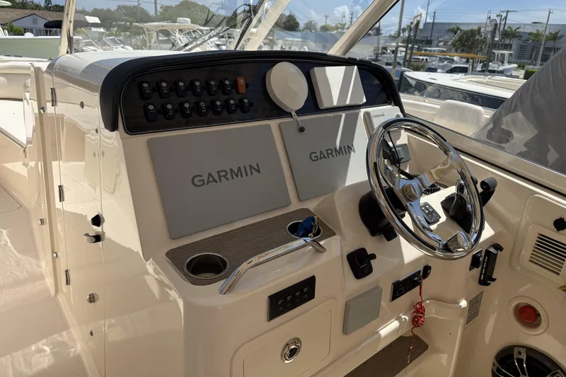335-714 Used Yacht Photos Pics 2021 Grady-White Freedom 335 boat dashboard with Garmin navigation system and steering wheel.