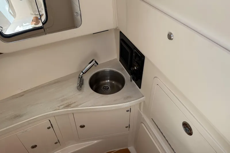 335-714 Used Yacht Photos Pics 2021 Grady-White Freedom 335 boat interior with sink and storage cabinets.