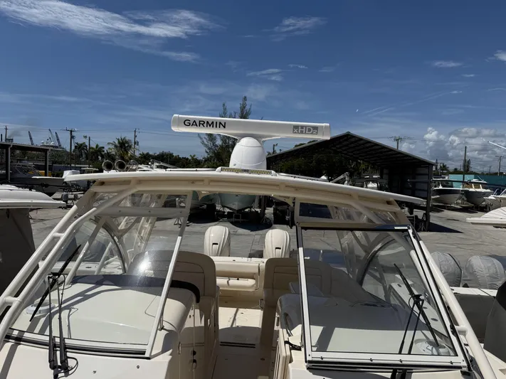 335-714 Used Yacht Photos Pics 2021 Grady-White Freedom 335 boat with Garmin xHD2 radar, docked under a clear blue sky.