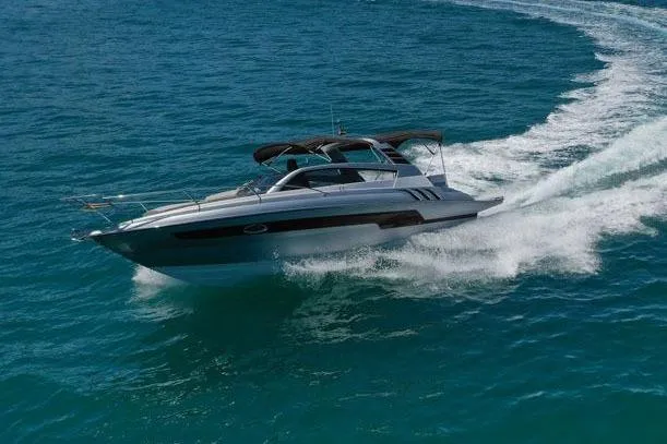 Custom Order Your 305 Today! Yacht Photos Pics 2025 Hanover 305 Inboard cruising on open sea with scenic mountain backdrop.