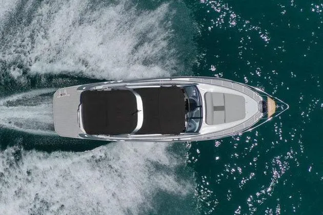 Custom Order Your 305 Today! Yacht Photos Pics Aerial view of 2025 Hanover 305 Inboard boat cruising on clear blue water.