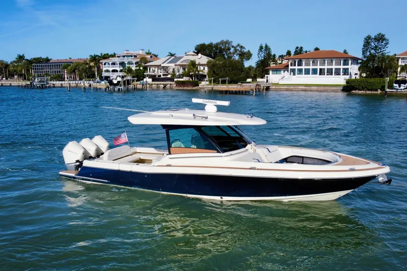  Yacht Photos Pics 2021 Chris-Craft Calypso 35 boat cruising on a sunny waterfront.
